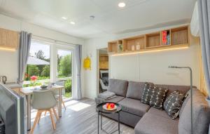 a living room with a couch and a table at Tiny House Wemding in Wemding