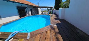 a swimming pool on a wooden deck next to a house at Bella Piscine in Marseille