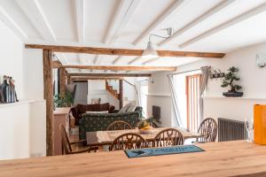 a living room with a wooden table and chairs at West Town Barn in Exeter