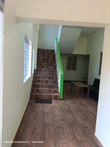 a staircase in a room with a green stair case at New green hotel in Yelagiri