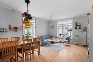 a living room with a table and a couch at Your Local Bergen Dream In The Heart Of The city in Bergen