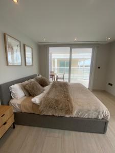 a bedroom with a large bed with a large window at Deluxe Marina View Seafront Gibraltar Stay in Gibraltar