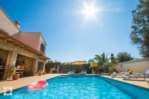 a swimming pool with chairs and a house at Villa Hugo 11 by Abahana Villas in Benissa