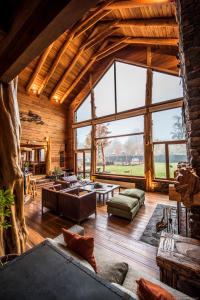 a large living room with a large window at Rocanegra Mountain Lodge in Las Trancas