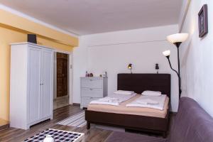 a bedroom with a bed and a dresser at Hedgehog Apartment near Margaret Island in Budapest