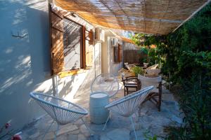 a patio with two chairs and a table at Filanthi - The project in Methoni
