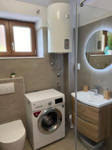 a bathroom with a washing machine and a sink at Villa Marinko in Umag