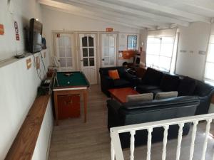 a living room with a couch and a pool table at Atatau Hostel in La Paz