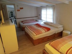a bedroom with two beds and a window at Atatau hostel in La Paz