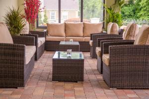 a patio with wicker chairs and couches and a table at Longcourt House Hotel in Newcastle West