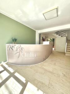 a lobby of a building with a sign on the wall at Oelia Rooms & Apartments in Agia Marina Aegina