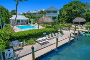 an aerial view of a resort with a pool and a dock at Isla Mirabelle - Waterfront Boutique Resort, Htd Pool, Dock, Walkable in Islamorada