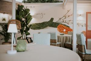 a dining room with a white table and chairs at Santa Catalina, a Royal Hideaway Hotel in Las Palmas de Gran Canaria