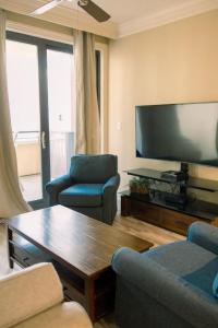 a living room with a large flat screen tv at Harborwalk Village Two Bedroom Vacation Rental in Destin