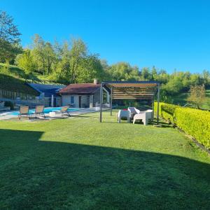 a backyard with a gazebo and a pool at Ca' del magu in San Michele Mondovì