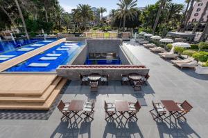 an overhead view of a pool with tables and chairs at Santa Catalina, a Royal Hideaway Hotel in Las Palmas de Gran Canaria