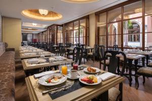 a row of tables in a restaurant with food on them at Santa Catalina, a Royal Hideaway Hotel in Las Palmas de Gran Canaria