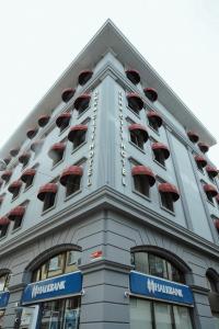 a building with many windows on the side of it at ONKA OTELCİLİK TURİZM TİCARET LİMİTED ŞİRKETi in Istanbul