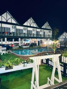 a view of a building with a pool at night at BERUNTUNG KE BARI RESORT @ PANTAI PENARIK in Kampong Bari Kechil