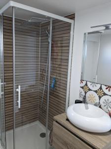 a bathroom with a sink and a shower at Villa Rive Ault in Ault