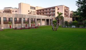 a green yard in front of a building at Santa Catalina, a Royal Hideaway Hotel in Las Palmas de Gran Canaria