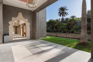 an internal view of a house with a dog in the hallway at Santa Catalina, a Royal Hideaway Hotel in Las Palmas de Gran Canaria