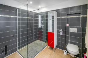 a bathroom with a glass shower and a toilet at Villa Rive Ault in Ault