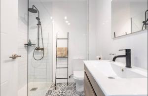 a bathroom with a shower and a sink and a toilet at Apartamentos Duque Cartagena in Cartagena +80 photos