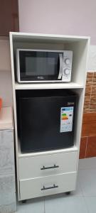 a microwave oven sitting on top of a white dresser at La Casita II in Cochabamba
