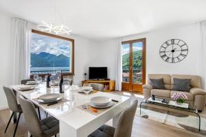 a white dining room with a table and chairs at Casa vacanza Guattini in Cremia