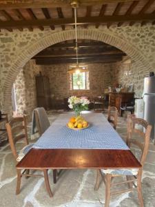 a table with a bowl of fruit on top of it at Casa Vista Maremma Tuscany in Roccatederighi