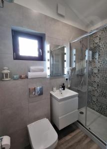 a bathroom with a toilet sink and a shower at Okno na Raj Domki całoroczne in Kudowa-Zdrój