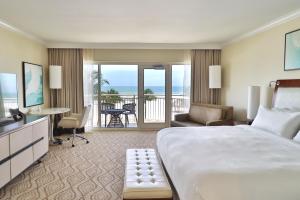 a hotel room with a large bed and a balcony at JW Marriott Marco Island Beach Resort in Marco Island