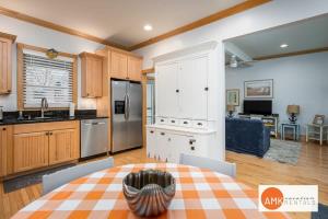 a kitchen and living room with a table and a dining room at Lake Life Getaway - Condo near downtown! in Douglas