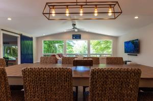 a dining room with a large wooden table and chairs at Beach View Cottage - On the Lake in Holland