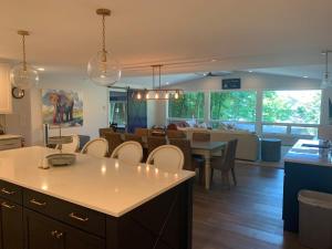 a kitchen and dining room with a table and chairs at Beach View Cottage - On the Lake in Holland
