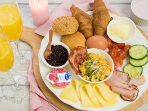 a plate of food with eggs bread and other foods at Guest Room Utrecht in Utrecht