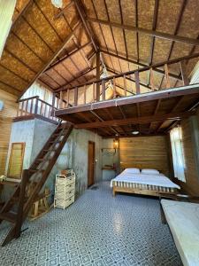 a large bedroom with a bed and a wooden ceiling at บ้านวารีชีวา WareeCheewa 