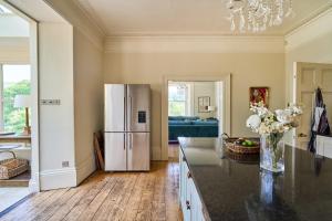 a kitchen with a refrigerator and a counter top at Berkeley House near Bath in Bath