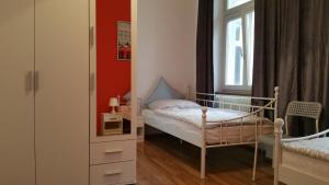 a small bedroom with a bed and a window at Pension Anna in Rastatt