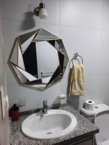 a bathroom with a sink and a mirror on the wall at Ámbar B3-P15-TC in Cochabamba
