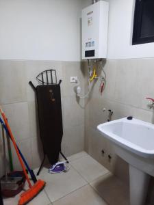 a bathroom with a sink and a toilet and a sink at Ámbar B3-P15-TC in Cochabamba