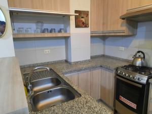 a kitchen with a sink and a stove at Ámbar B3-P15-TC in Cochabamba