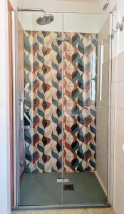 a shower with a glass door in a bathroom at Casa Di Pam in Scicli