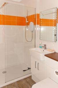 a bathroom with a shower and a sink at Covenanters Cottage , Balmaclellan in Castle Douglas