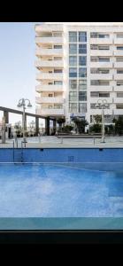 a large swimming pool in front of a large building at Tanger centre-ville - Appartement luxueux avec vue mer et piscine in Tangier +2 photos