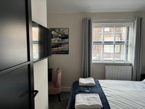 a small bedroom with a bed and a window at Pilgrim House by Phoenix Collection in Liverpool