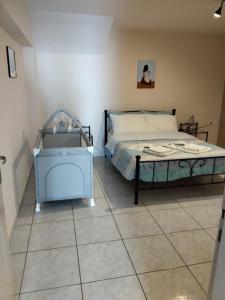 een slaapkamer met een bed en een tegelvloer bij Maria's Modern Apartment , Monemvasia in Monemvasia