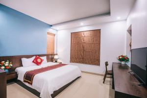 En eller flere senge i et værelse på Villa Sao Biển 15 FLC Sầm Sơn + 14 billeder