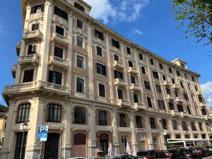 a large white building with a clock tower at Blue Sea View Apartment in Salerno